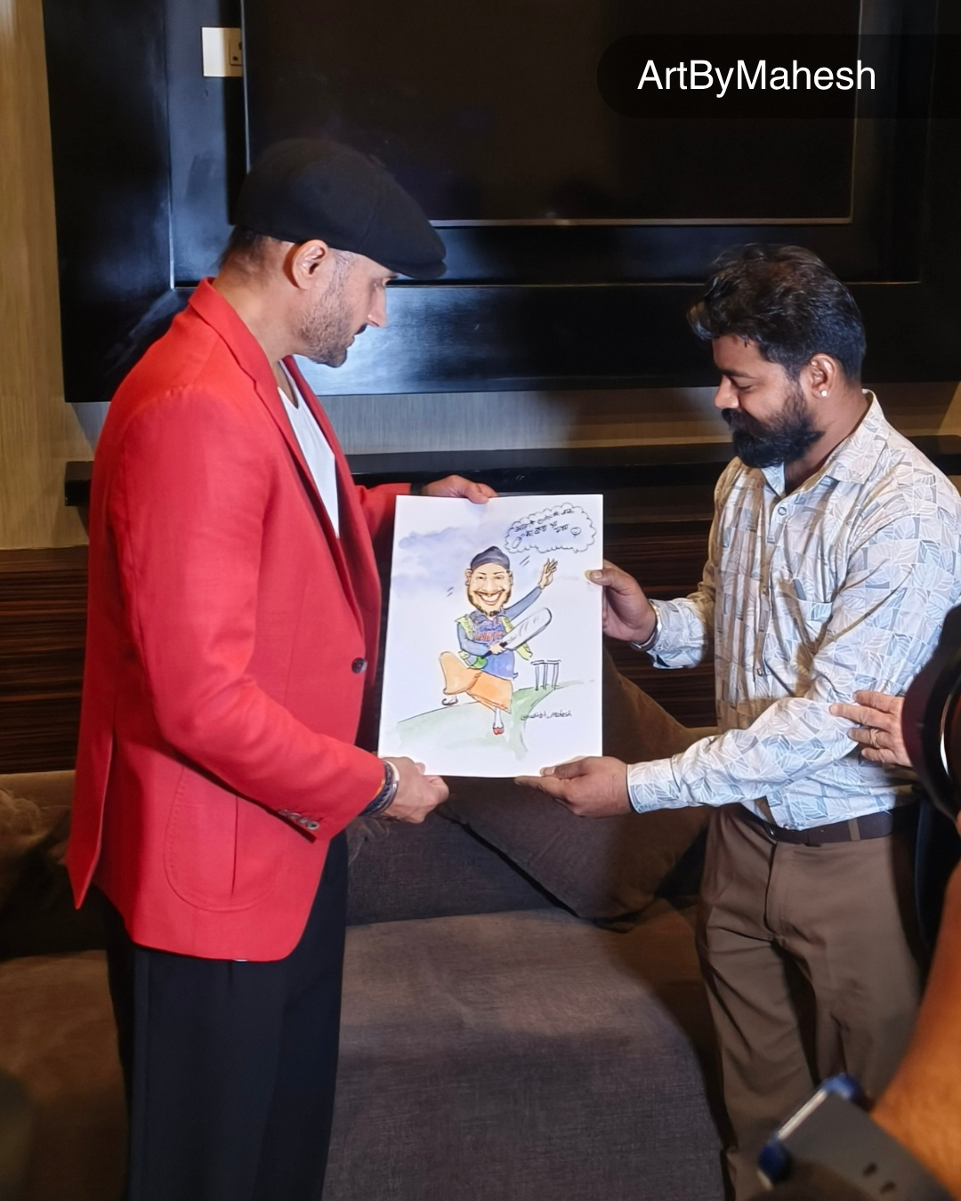 Caricature artist Mahesh Kumawat presenting a hand-drawn caricature to Harbhajan Singh at a live event